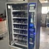 Used Crane 471 Merchant Media combo vending machine with touchscreen